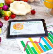 Organic food and a Tablet PC showing information about healthy nutrition and phytochemical composition.